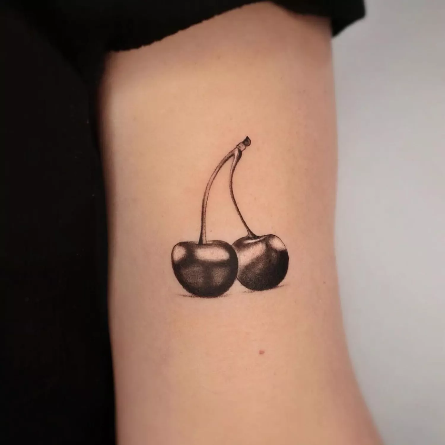 cherries with stem tattoo on inner upper arm