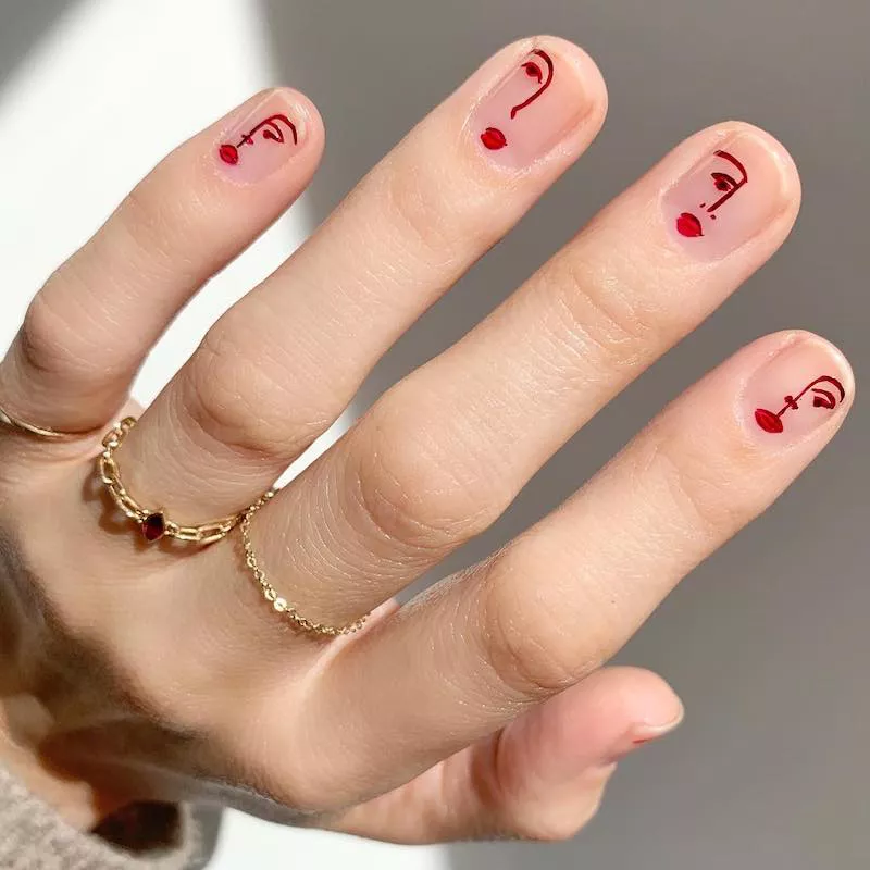 Valentine's Day Nail Designs with line drawings of faces