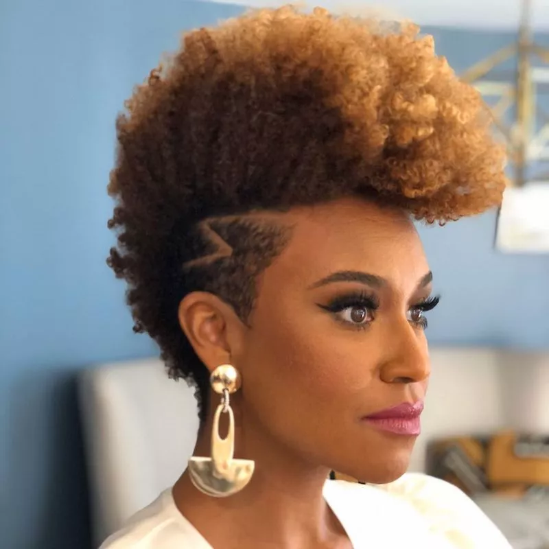 Woman with mohawk Afro hairstyle and tapered sides
