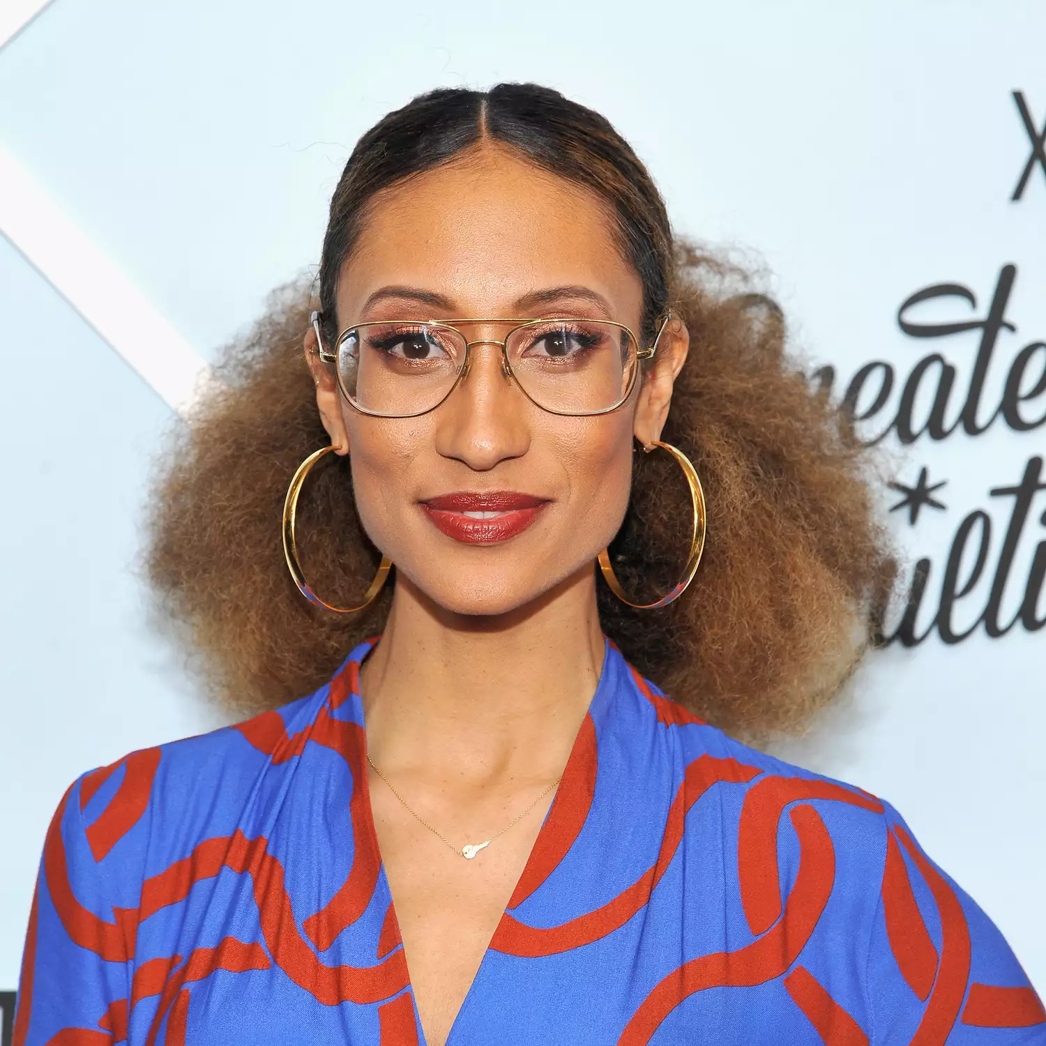 Elaine Welteroth with an afro hairstyle pulled into a low ponytail