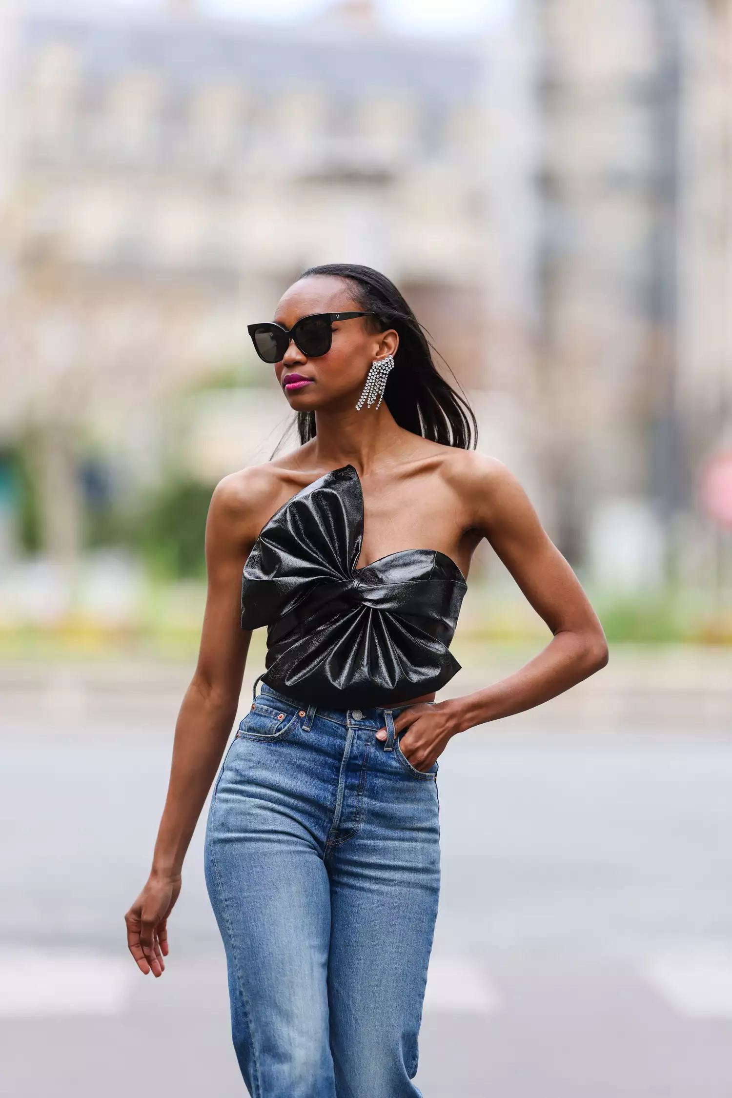 Emilie Joseph wears a bow top and statement earrings