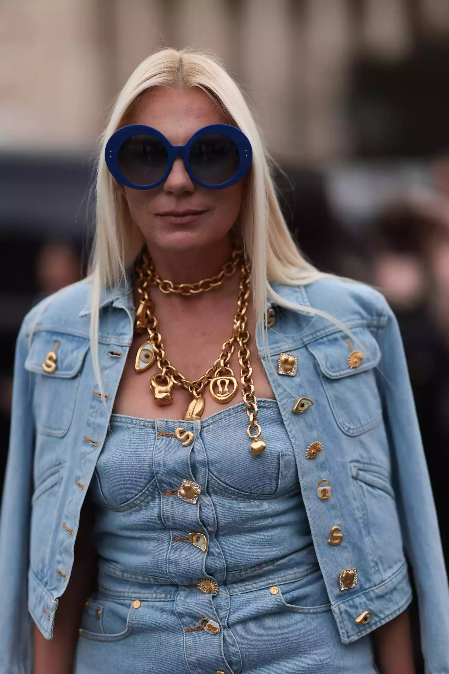 Corina Mihaila Larpin wears a statement necklace with a denim corset top