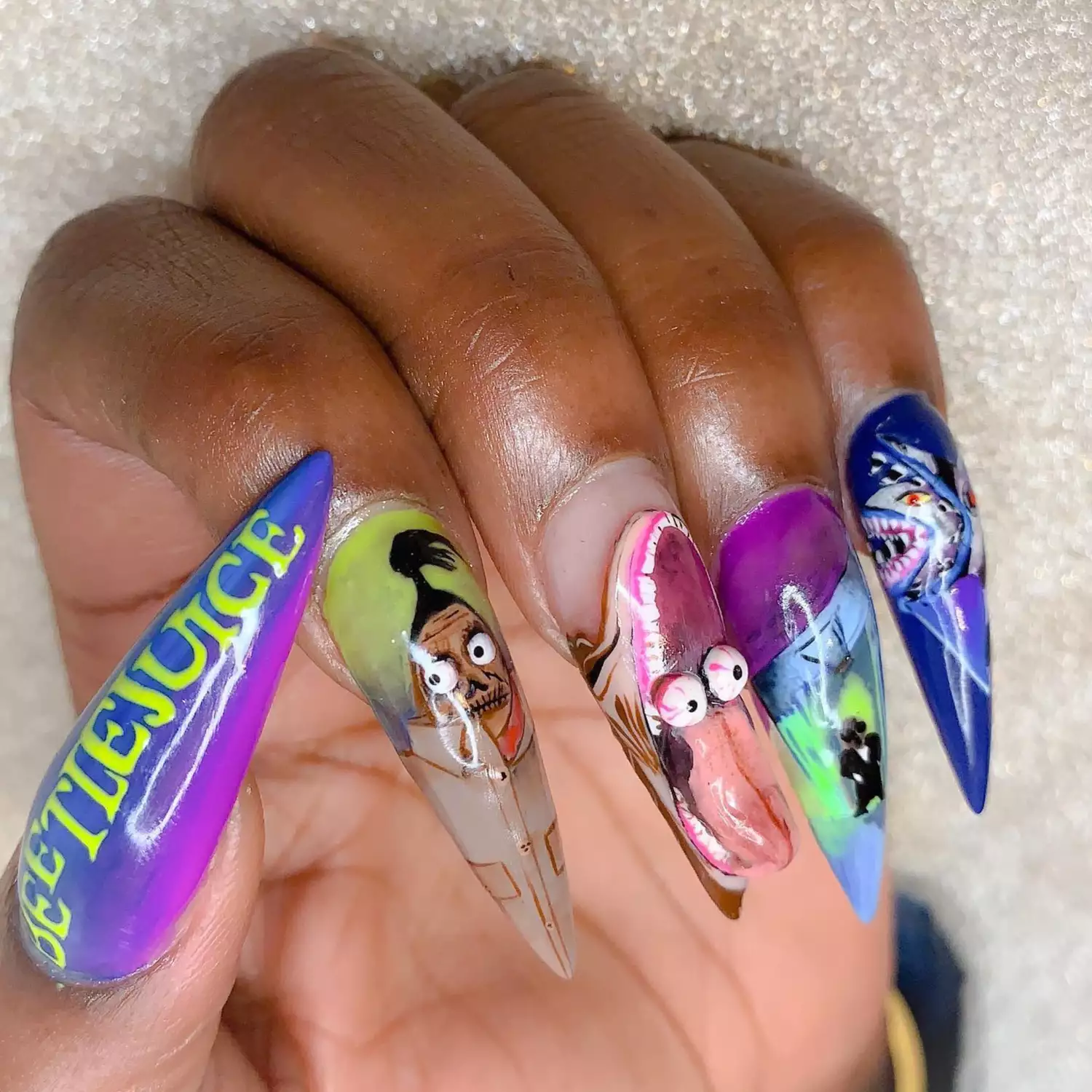 Hand-painted nails inspired by Beetlejuice characters.