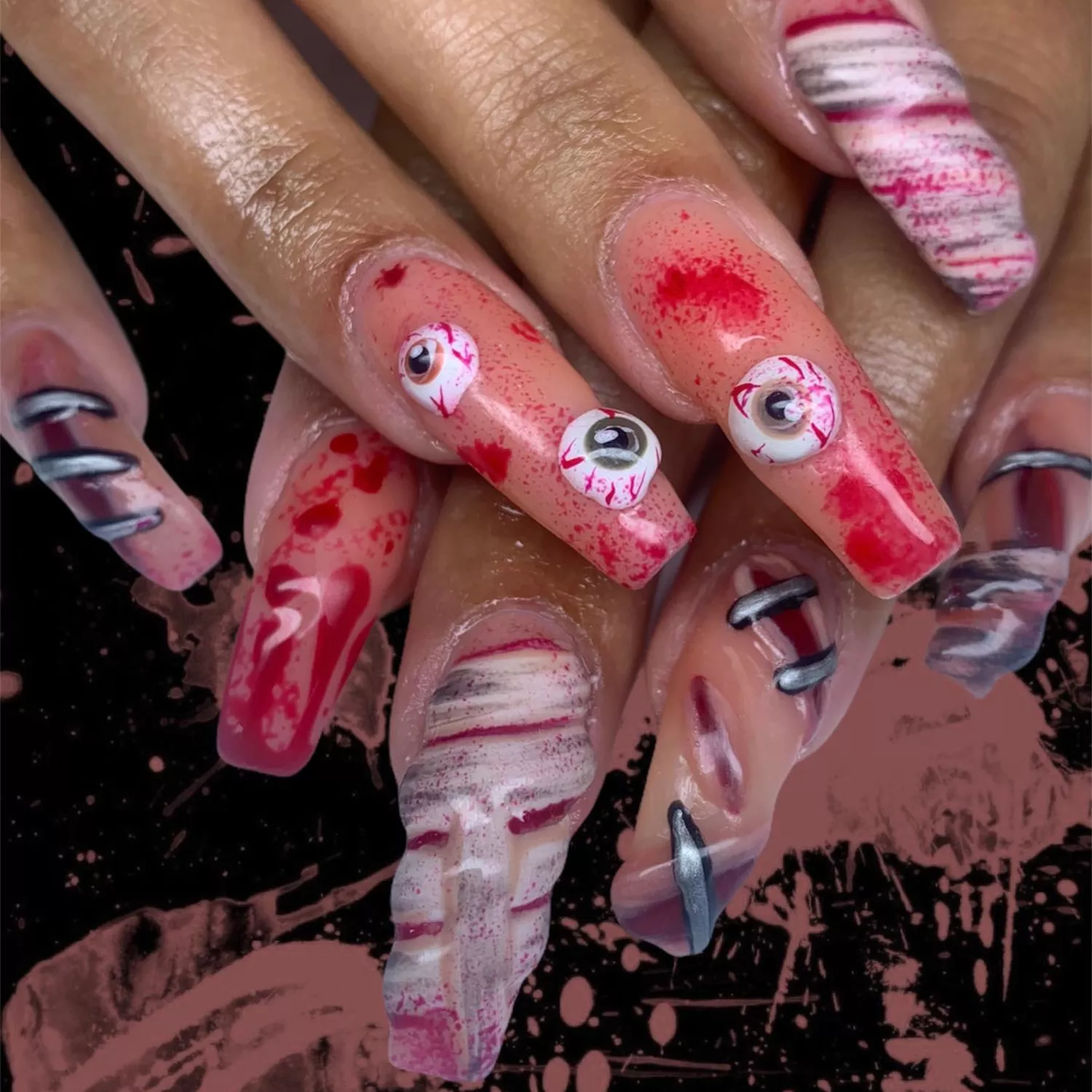 Long square nails with bloody eyeball and stitch nail art.