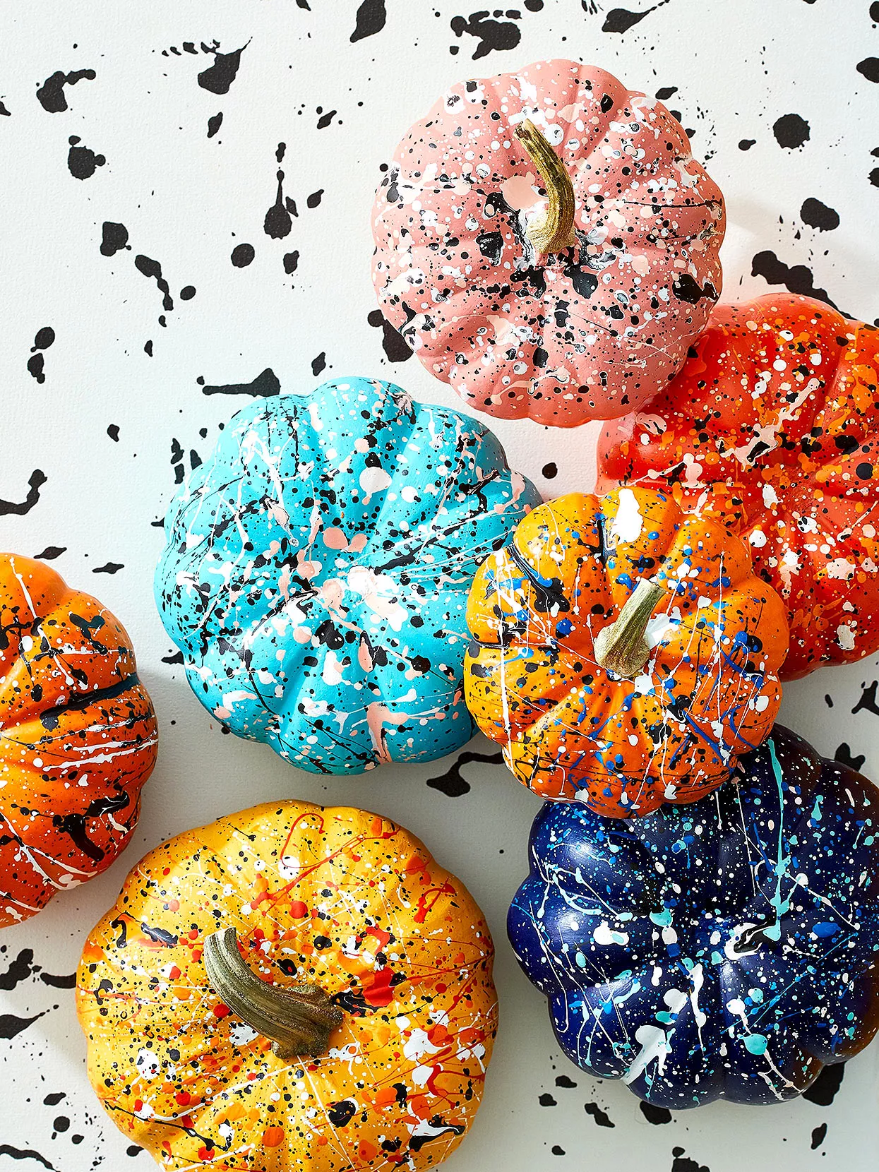 mini splatter painted pumpkins on splatter background