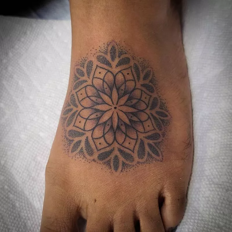 Dotted mandala tattoo on foot with gradient edges