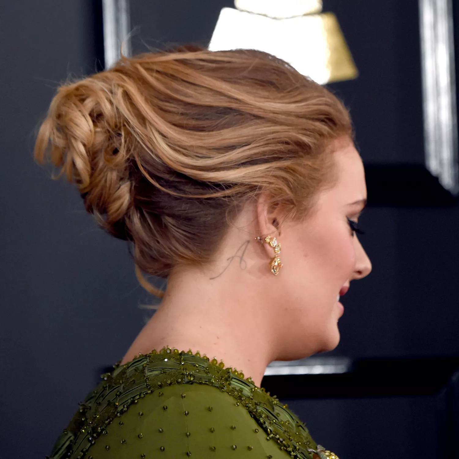 Adele with "A' initial tattoo on her neck behind the ear