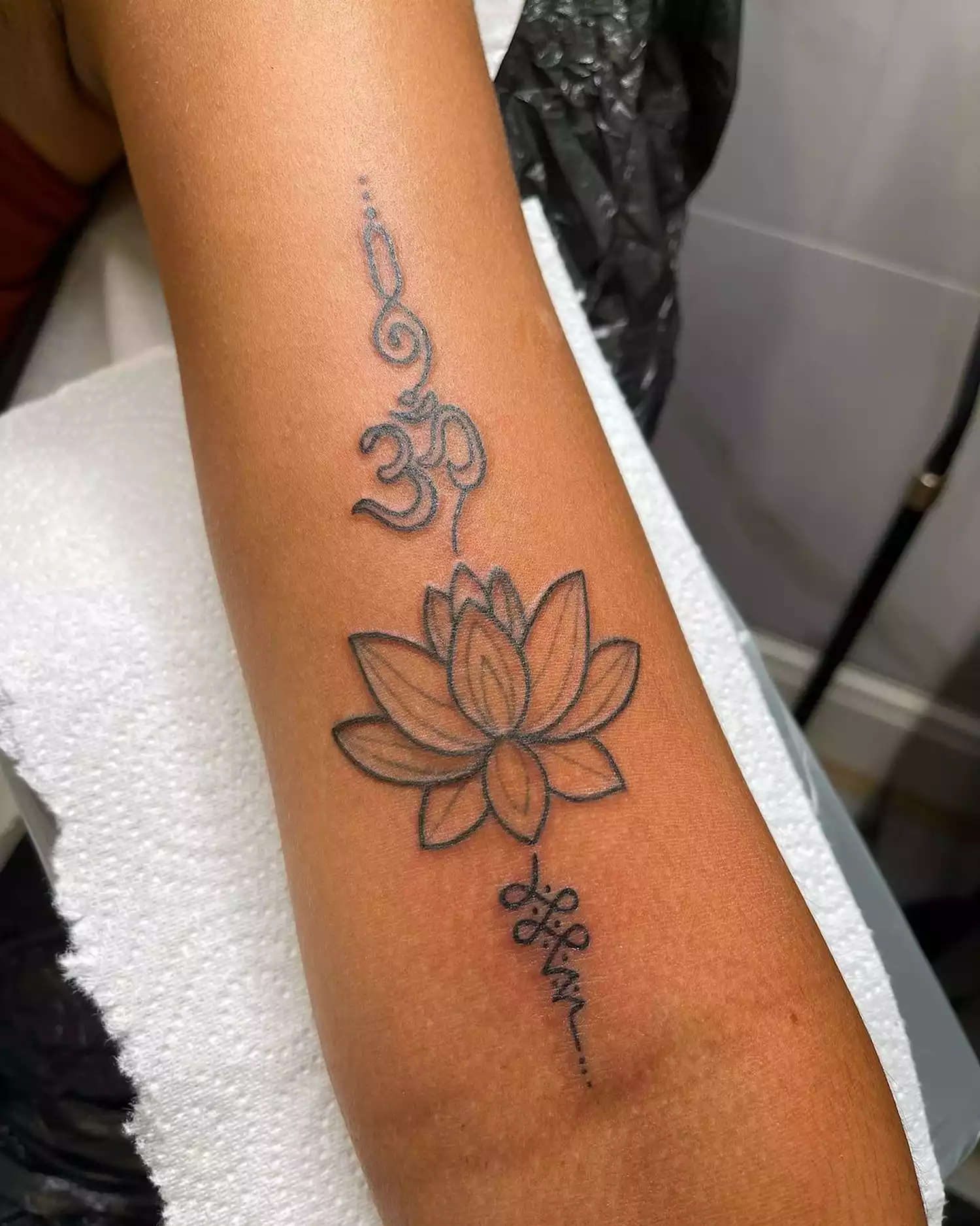 A lotus flower with oum motif tattoo