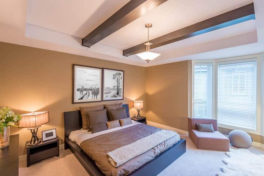 Bedroom with gold accents and coffered ceiling