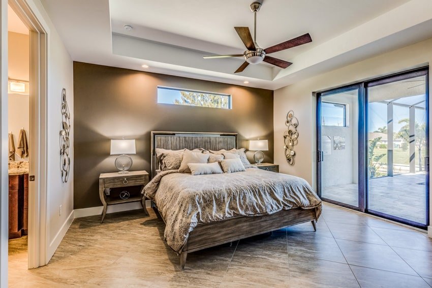 Spacious bedroom with wall of gold and porcelain floor